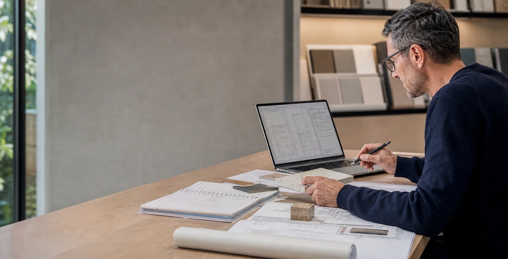 Architect working with product samples and technical information